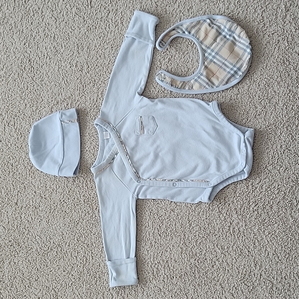 Burberry Childern side snap onesie, hat, and a matching bib.